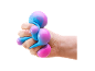 Hand squeezing a blue and purple stress ball.