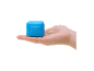 Hand holding a blue square stress ball with text on it
