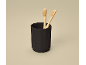 Two bamboo toothbrushes in a black ribbed cup.