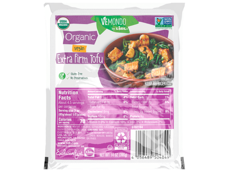 Organic extra firm tofu in a clear package with a serving suggestion of cooked tofu and greens.