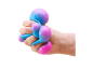 Hand squeezing a blue and pink stress ball.