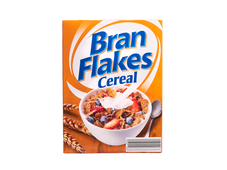 Bran flakes breakfast cereal box with berries and milk in bowl, with wheat ears