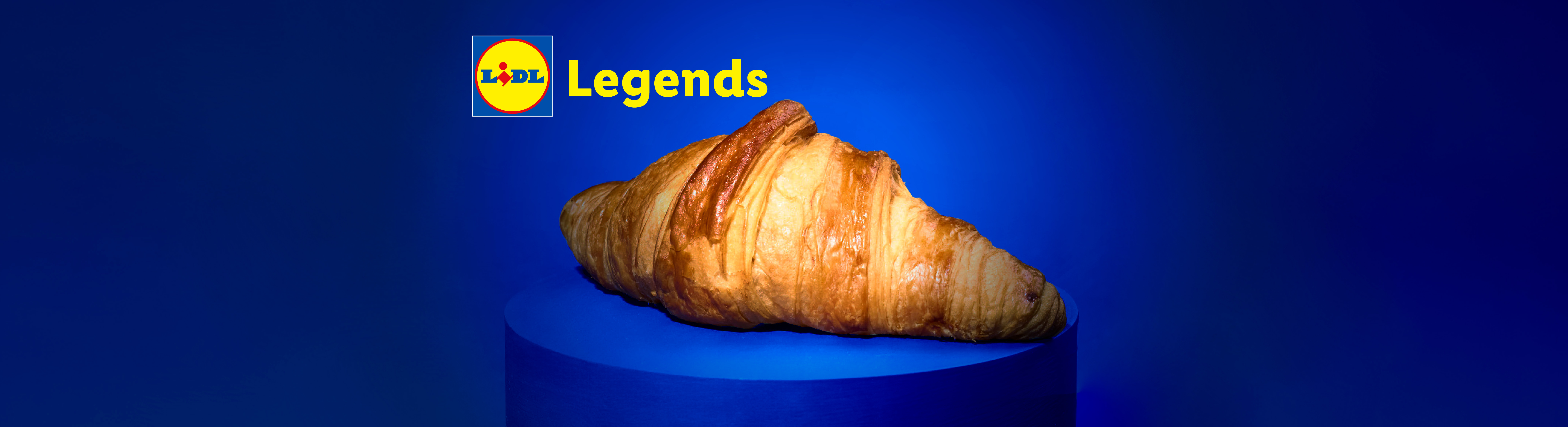 A golden croissant on a blue pedestal, with the text 'Legends' above it.