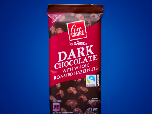 Dark chocolate bar with whole roasted hazelnuts, featuring a Fairtrade cocoa label.