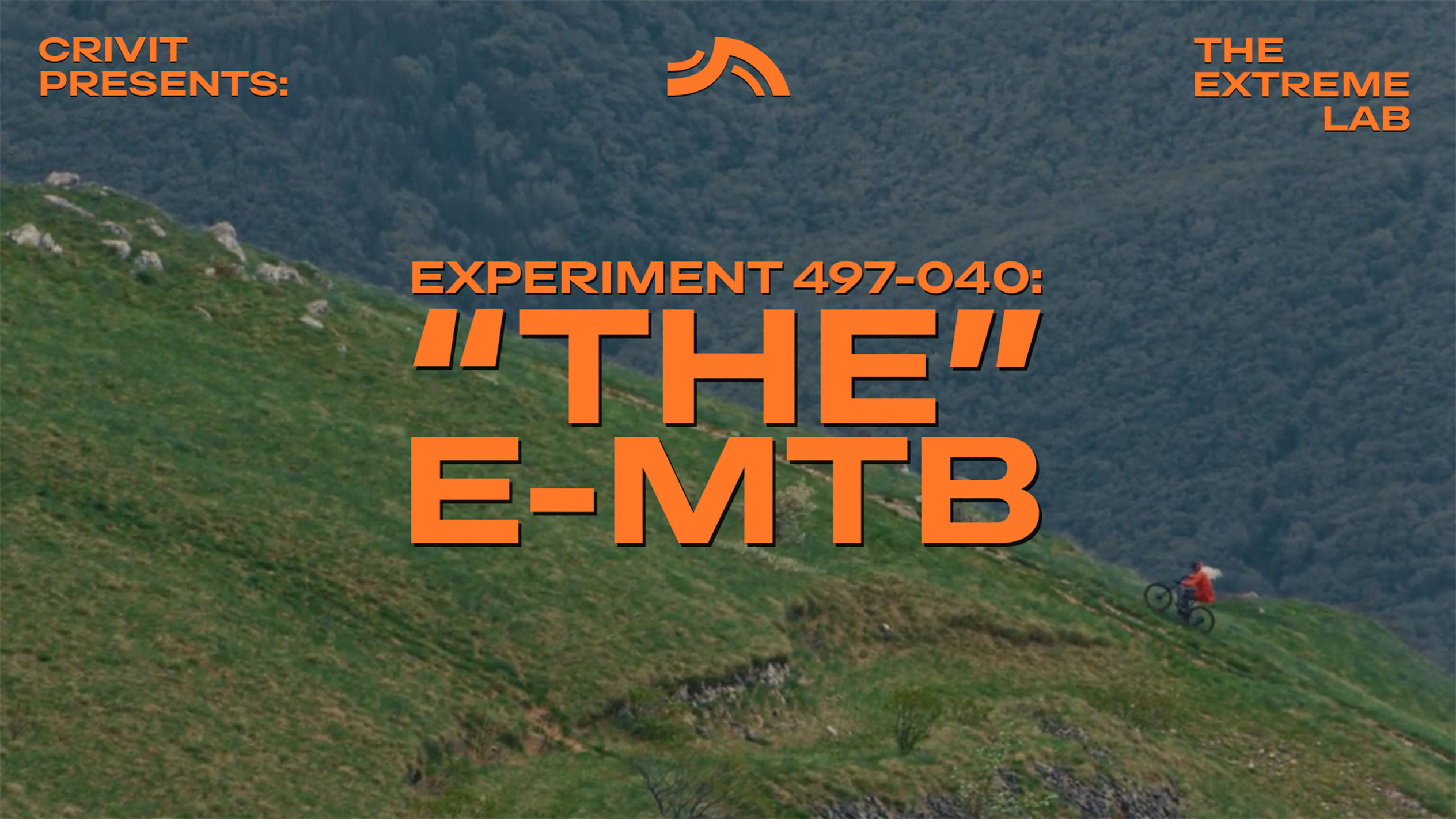 Mountain biker on a grassy slope, with text 'THE E-MTB' and 'THE EXTREME LAB'.
